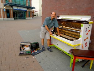 Jurgen Goering repairs Nanaimo's Public Piano